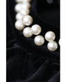 A medium-length velour-like dress with a pearl neck that wraps around you