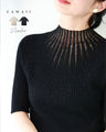 A streamlined ribbed cut-and-sew top with light particles falling on it