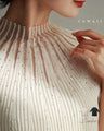 A streamlined ribbed cut-and-sew top with light particles falling on it