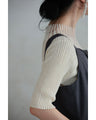 A streamlined ribbed cut-and-sew top with light particles falling on it