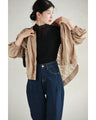A streamlined ribbed cut-and-sew top with light particles falling on it