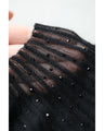 A streamlined ribbed cut-and-sew top with light particles falling on it