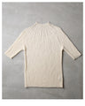 A streamlined ribbed cut-and-sew top with light particles falling on it