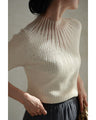A streamlined ribbed cut-and-sew top with light particles falling on it