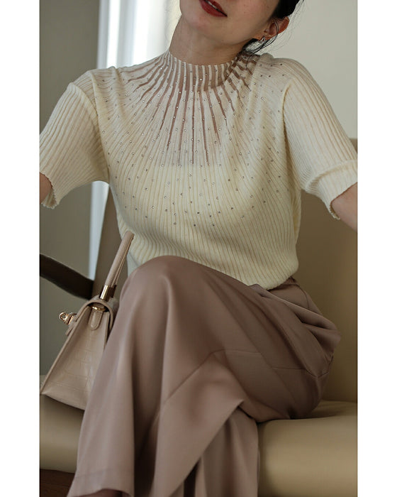 A streamlined ribbed cut-and-sew top with light particles falling on it