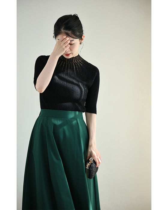 A streamlined ribbed cut-and-sew top with light particles falling on it