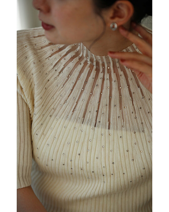 A streamlined ribbed cut-and-sew top with light particles falling on it