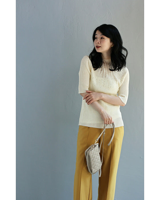 A streamlined ribbed cut-and-sew top with light particles falling on it