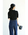 A streamlined ribbed cut-and-sew top with light particles falling on it