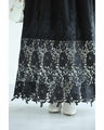A long dress with lace that spreads out at the feet