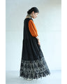 A long dress with lace that spreads out at the feet
