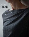 A thin cut-and-sew top with draping and sparkling rhinestones