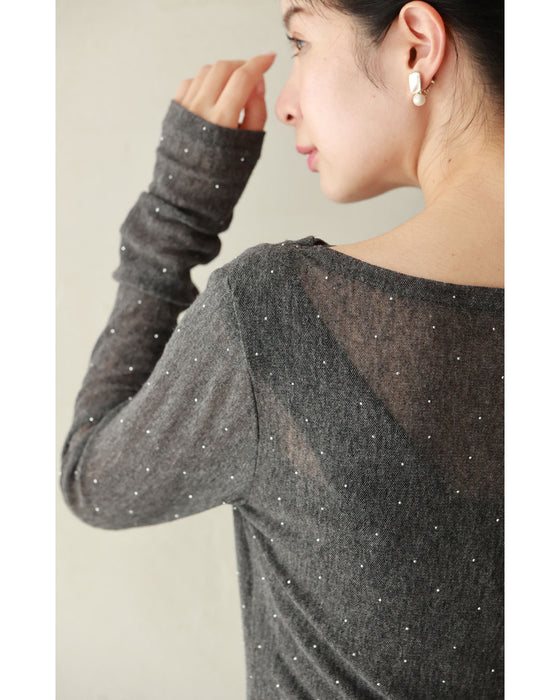 A thin cut-and-sew top with draping and sparkling rhinestones