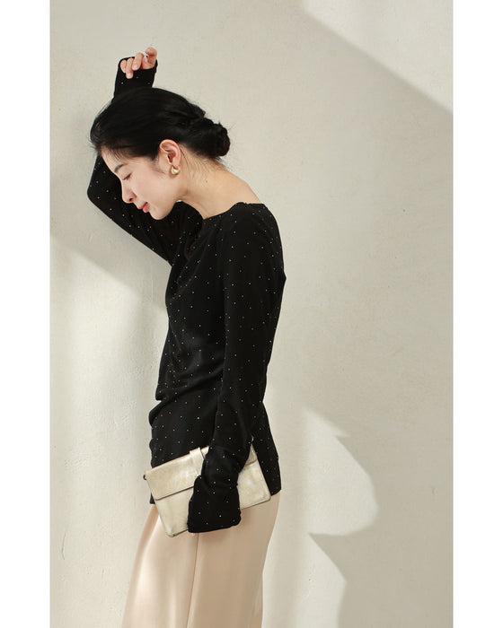 A thin cut-and-sew top with draping and sparkling rhinestones