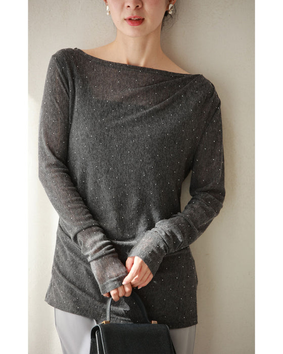 A thin cut-and-sew top with draping and sparkling rhinestones