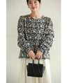 A floral embroidered pullover top with sparkling fine sequins