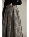 A tucked long skirt with nuanced art