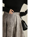 A tucked long skirt with nuanced art