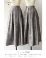 A tucked long skirt with nuanced art