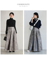 A tucked long skirt with nuanced art