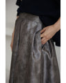 A tucked long skirt with nuanced art