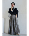 A tucked long skirt with nuanced art