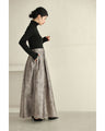 A tucked long skirt with nuanced art
