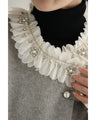 A pearl button coat with sparkling beaded daisy frills