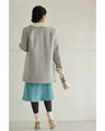 A pearl button coat with sparkling beaded daisy frills