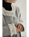 A pearl button coat with sparkling beaded daisy frills