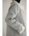 A pearl button coat with sparkling beaded daisy frills
