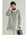 A pearl button coat with sparkling beaded daisy frills