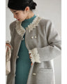 A pearl button coat with sparkling beaded daisy frills