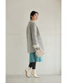 A pearl button coat with sparkling beaded daisy frills