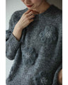 Knitted pullover top with appliqued flowers