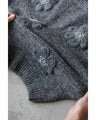 Knitted pullover top with appliqued flowers