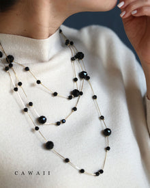  A long necklace with interlocking cut stones of different sizes