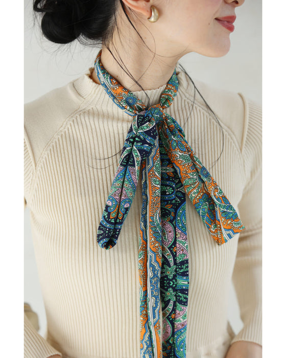 オリエンタルな柄が広がるドッキングプリーツミディアムワンピース(リボン付き)