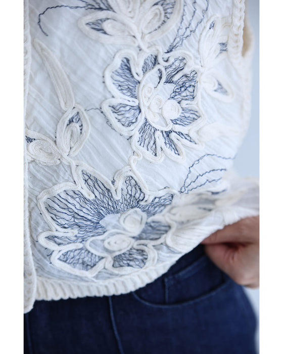 コード刺繍の花が浮かぶ短丈クロシェベスト