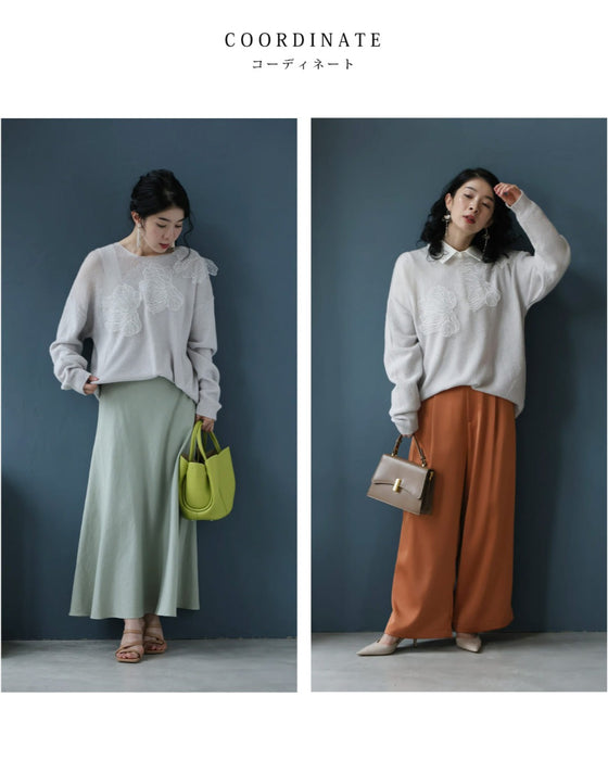 アシンメトリーなシアーデコルテの白花ニットプルオーバートップス