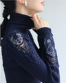 A turtleneck knit top with beautifully transparent lace on the shoulders and sleeves