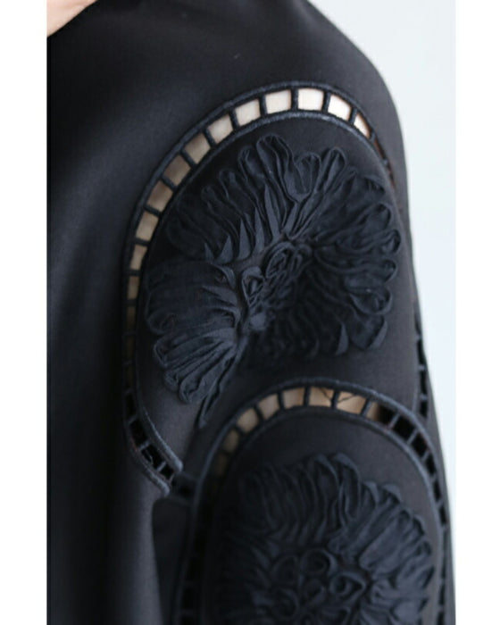 Glossy pullover top with floral relief sleeves