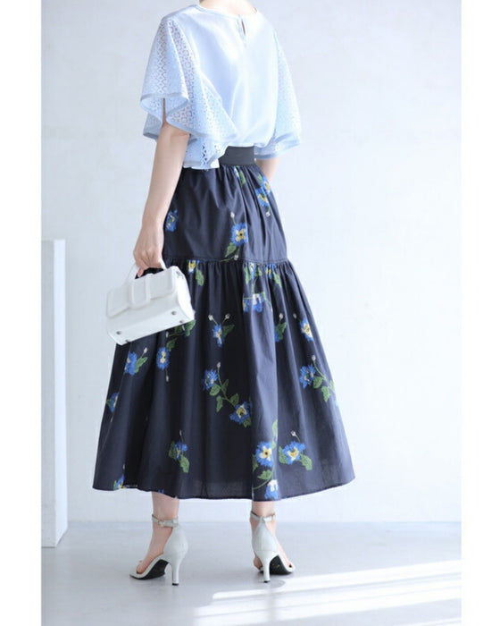 A fluffy mid-length skirt with a lovely blue flower design