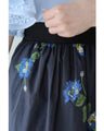A fluffy mid-length skirt with a lovely blue flower design