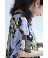 A sheer floral mid-length dress with pleats that flares out from the neck