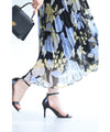 A sheer floral mid-length dress with pleats that flares out from the neck