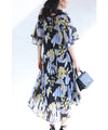 A sheer floral mid-length dress with pleats that flares out from the neck