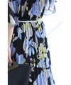 A sheer floral mid-length dress with pleats that flares out from the neck