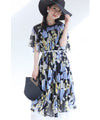 A sheer floral mid-length dress with pleats that flares out from the neck