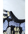 A sheer floral mid-length dress with pleats that flares out from the neck